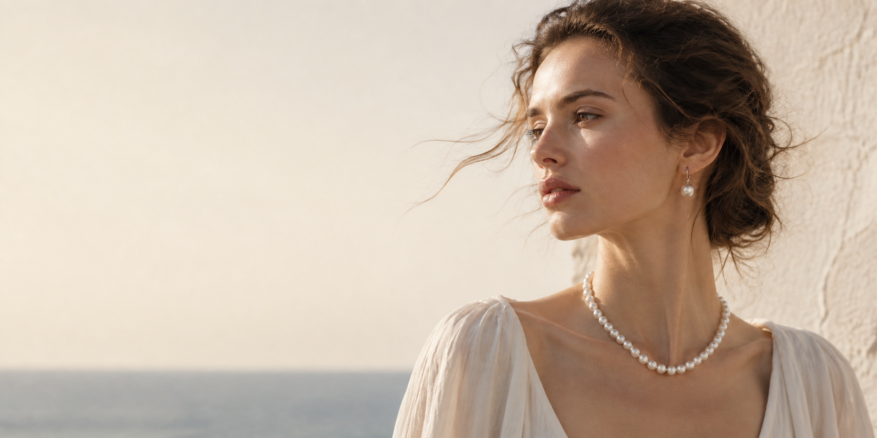 Woman wearing a classic freshwater pearl necklace and pearl earrings